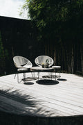 Weathered teak garden furniture near trees - placeholder photo