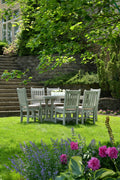 Wooden dining table set on grass - placeholder photo